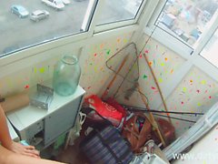 Tempting brunette girl with a sweet ass fucks a hard pole on a balcony