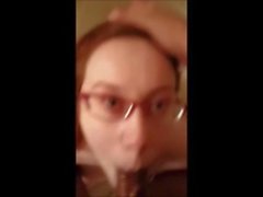 Redhead MILF with glasses sucking cock