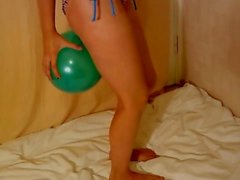 Fitness girl blow up ballon with legs